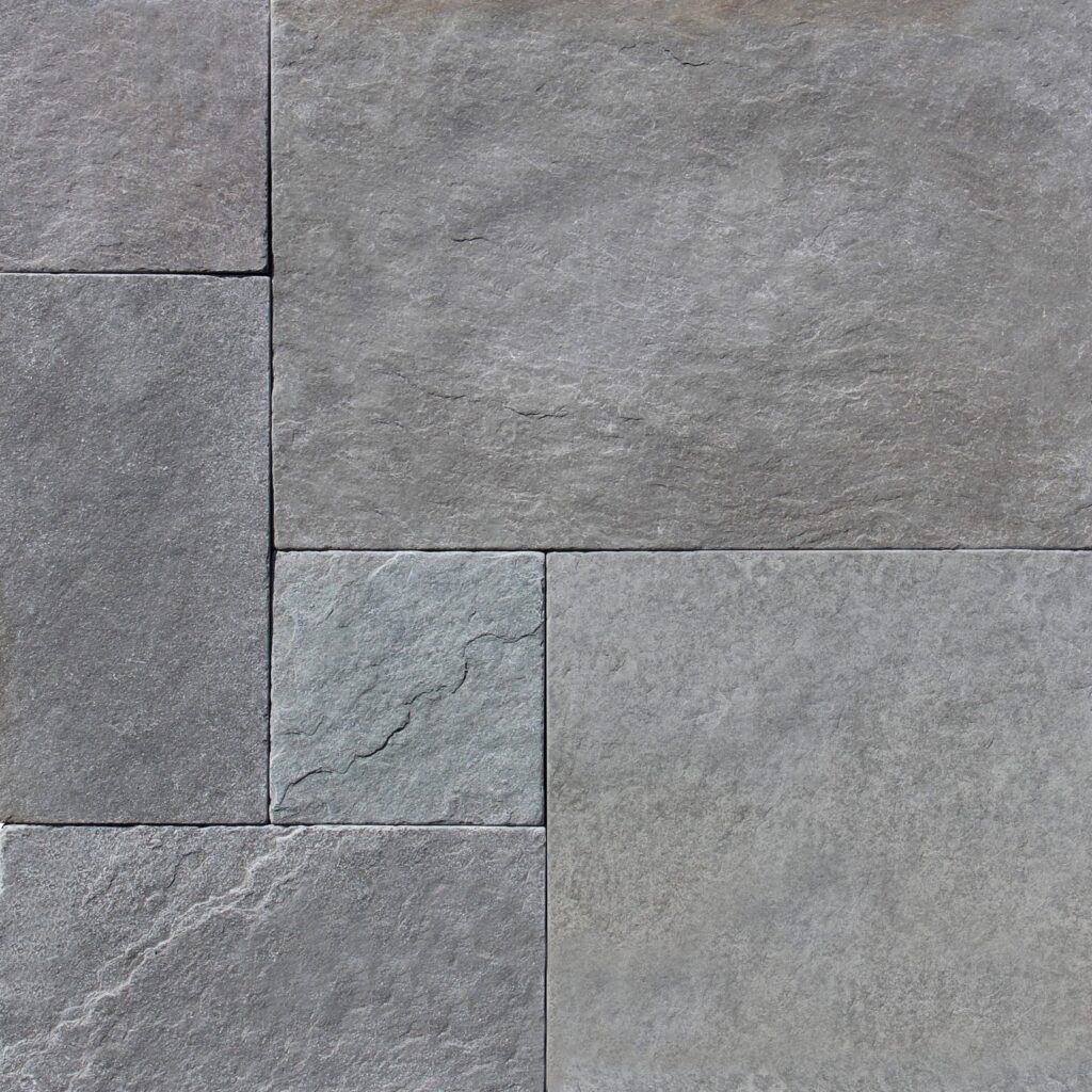 A piece of Indigo Grey French Pattern (Tumbled) paver tile